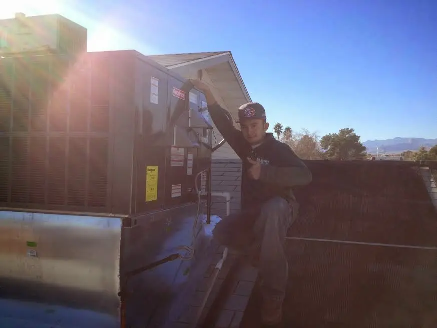 HVAC technician performing HVAC Inspection on a rooftop unit in Clawson